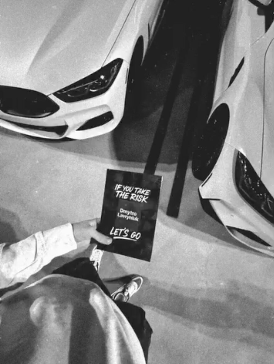 If You Take The Risk held over two sports cars